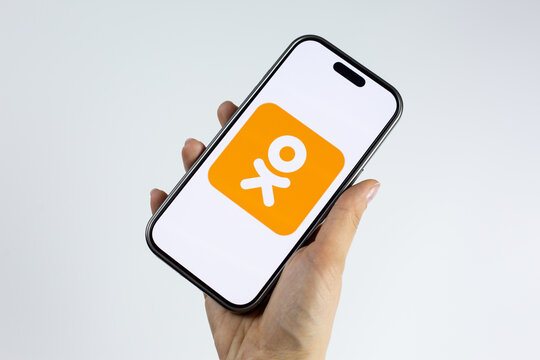 Moscow, Russia, March 14, 2026: Hand holding smartphone with the Odnoklassniki logo on screen, isolated. Visual representing everyday social media usage and staying connected with friends online
