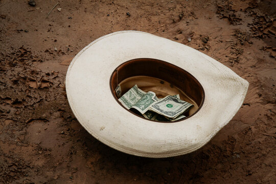 Cowboy hat holding cash at a rodeo