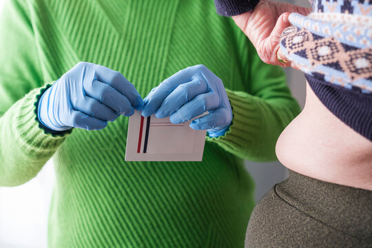 Detail of opening an envelope containing a fentanyl patch.