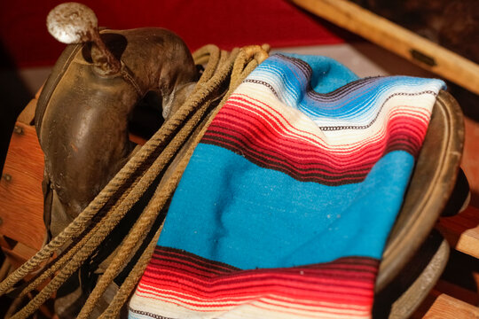 Western saddle blanket and rope close up, cowboy ranch still life