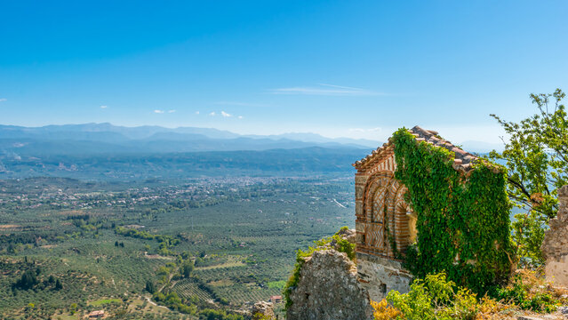 Panoramic view of ruins in Mystras archeological site with valley and Sparta below, Laconia, Peloponnese, Greece