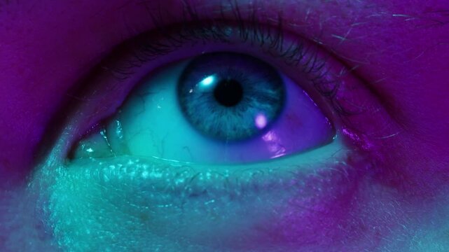 Detailed blue eye with strong gaze, showing human anatomy and beauty, thriller depression halloween style. Drugs concept.