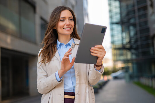 Professional woman using tablet for mobile business outdoors