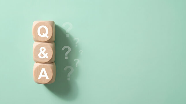 q and a letters on wooden cubes with question marks on green background for faq support customer service help desk help center and frequently asked questions concept 