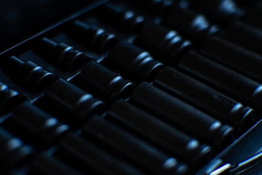 Deep impact socket set in a black metal carrying case, captured in a high-contrast cinematic style.