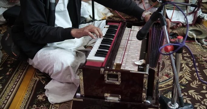 Close-up of harmonium playing during bhajan, showcasing rhythm, melody, and traditional Indian devotional music performance