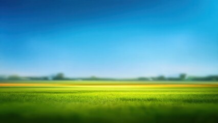 Obraz premium Vibrant Green Field and Bright Blue Sky Landscape Background