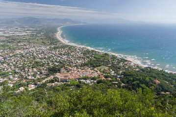 Aerial View of Coastal Town with Forest and Long Beach