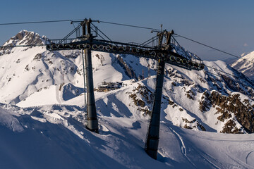 SkiLift, Alps Mountains, Winter: Aerial view of ski lift infrastructure in snowy Alps during winter, showcasing transportation for skiers.