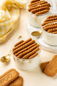 The viral two ingredient Japanese yogurt cheesecake, homemade no-bake, high-protein dessert made by inserting hard Lotus cookies Biscoff into a Greek yogurt. Vertical image.
