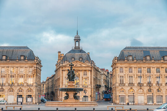 Place de la Bourse and Three Graces fountain historic square with classical architecture in Bordeaux city center at sunrise, Gironde, Nouvelle-Aquitaine, France. Travel and touristic landmark