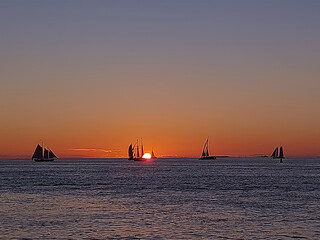 Sails at Twilight: Silhouetted Ships on the Horizon During a Key West Sunset © Rob