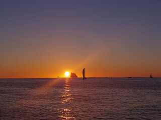 Sails at Twilight: Silhouetted Ships on the Horizon During a Key West Sunset © Rob