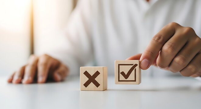 Hand choosing between wooden blocks with checkmark and cross symbols decision choice right