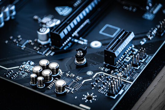 Computer motherboard showing capacitors and expansion slots
