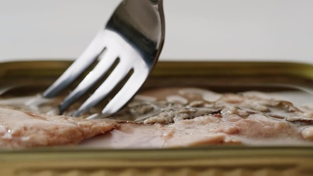 Cod liver superfood can, omega 3 Smoked cod liver in oil in open tin can with fresh greens on wooden table. Seafoods delicacy
