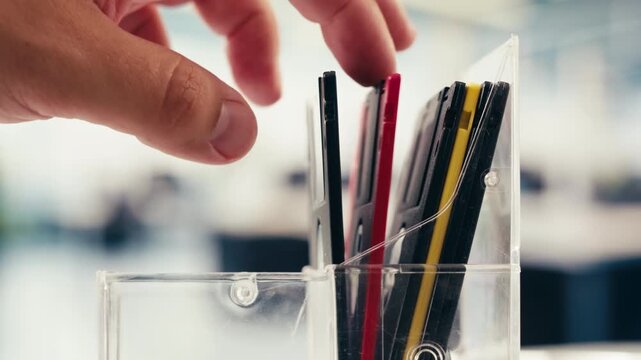 Floppy disc FDD close up, Using diskette for old PC computer macro. Archive programme or Music recorder, playing retro computer games. Vintage device for office, obsolete technology. 