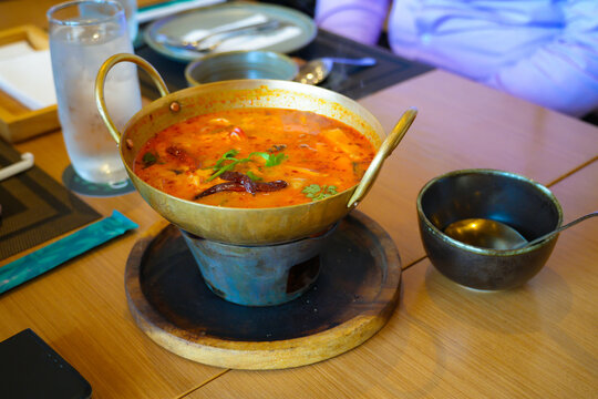 Tom Yum Goong, traditional Thai spicy shrimp soup with lemongrass, chili, lime juice and aromatic herbs.Famous Thai cuisine known for its hot and sour flavor.