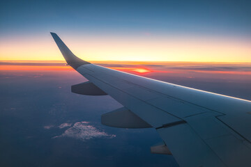 Aerial view from the plane over fluffy clouds