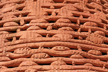 Handcrafted intricate terracotta carvings creating a detailed pattern © ANTONIO