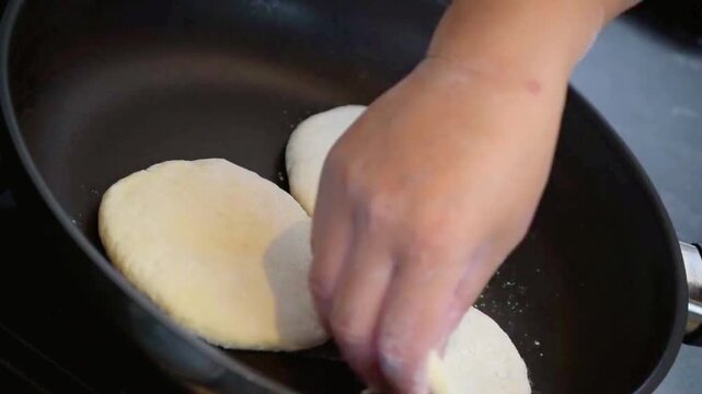 Handmade Flatbread Cooking in a Pan with Steam and Golden Crust.