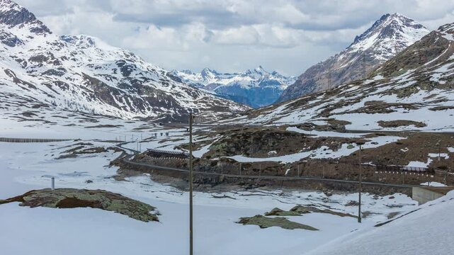 Time lapse, panoramic view on a train going through high mountain pass in the Swiss Alps. Bernina Railway, Bernina Pass, canton Graubuenden, Switzerland.