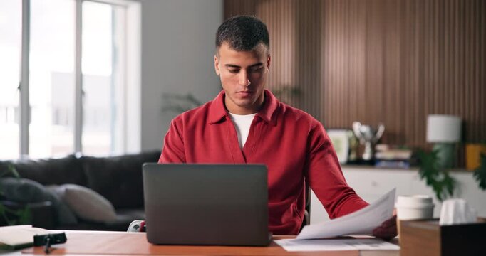 Laptop, review and man with paperwork for remote work, data entry and update records for bookkeeping. Reading, info maintenance and freelancer with pc to transcribe document, check and audit in home