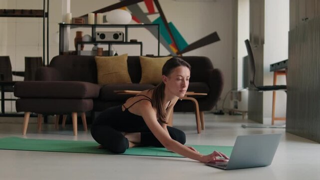 Young Woman Doing Yoga With Online Class