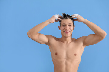 Obraz premium Man washing his hair with shampoo on light blue background, space for text