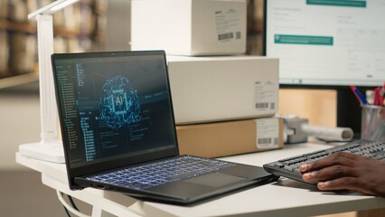 Black depot worker scanning awb tags next to AI brain neural networks system on pc, registering shipment details and airway bills for express delivery in logistics hub. Man in hi vis vest. Camera B. © DC Studio