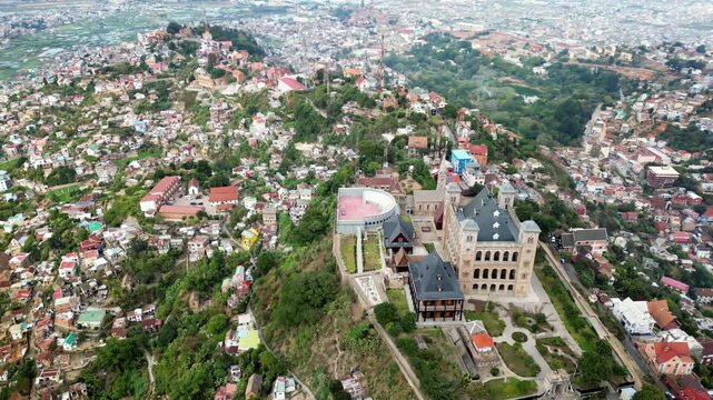 Aerial drone view of Rova of Antananarivo royal palace complex, perched above the city and surrounded by tightly packed houses on the hillsides of Madagascar's capital