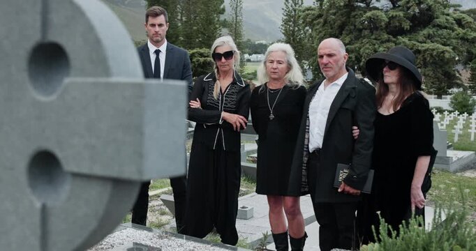 Sad, people and headstone at graveyard for funeral ceremony, burial service and mourning loss. Grief, family and cemetery for bereavement, goodbye ritual and tribute gathering at farewell memorial