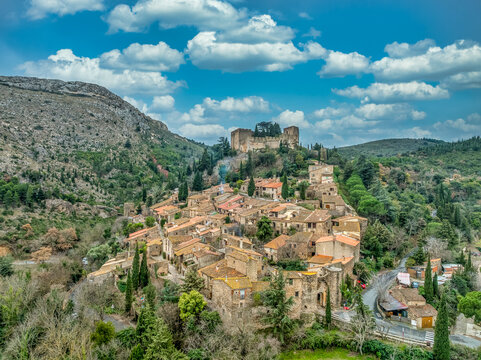 France&rsquo;s Hidden Gem: The Military Engineering and Gothic Elements of Castelnou Castle Most Beautiful Fortified Village, cloudy blue sky