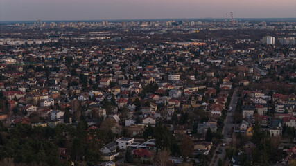 Fototapeta premium Aerial dusk view of Warsaw suburbia toward skyline and radio masts