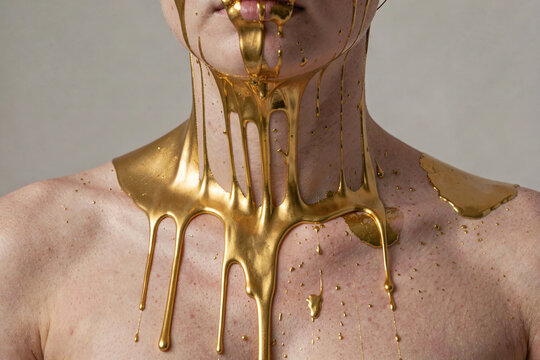 Golden Elixir: Abstract Beauty of Liquid Gold on Skin