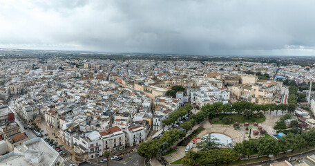 Fototapeta premium Explore Conversano: Aerial view of Norman-Swabian Castle, Romanesque Cathedral San Benedetto Monastery. Stone-carved gem in the heart of Puglia, Italy