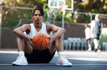 Confidence, ball or athlete on basketball court with portrait, fitness hobby or practice in weekend game. Serious, bokeh or man with roundball, hoop sport and training session with competition. © peopleimages.com