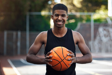 Confidence, portrait or athlete on basketball court with ball, fitness hobby or practice on weekend. Pride, happy or black man outdoor with roundball, hoop sport or training session in free time © peopleimages.com