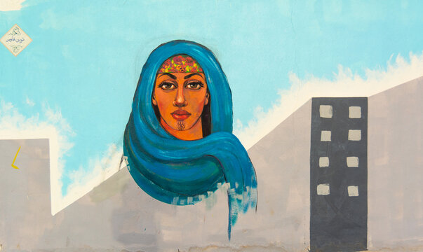 North African Woman Mural with Blue Headscarf in Urban Setting in Dahab