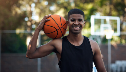 Happy, portrait or athlete on basketball court with ball, fitness hobby or practice on weekend. Confidence, bokeh or black man outdoor with roundball, hoop sport or training session in free time © peopleimages.com