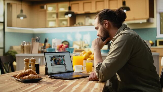 Adult man, online video content on laptop, streaming platform for digital clips, free to watch video supporting relaxed lifestyle moment at home. Enjoying online entertainment, everyday life.