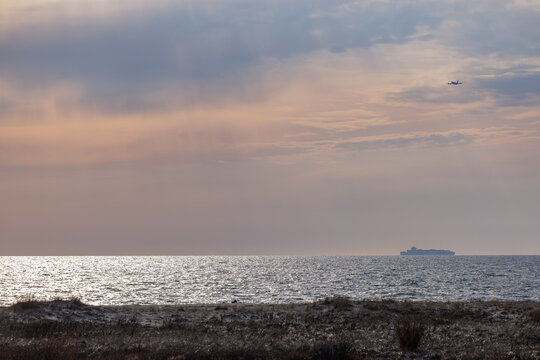 Cargo Ship and Aircraft on Horizon at Sandy Hook Beach New Jersey