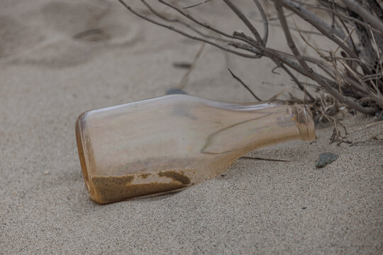 Weathered Glass Bottle Half Buried in Sand at Sandy Hook Beach New Jersey