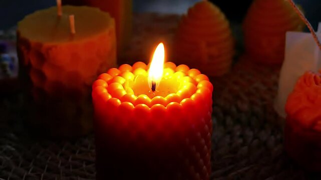 A candle burns in the dim light.