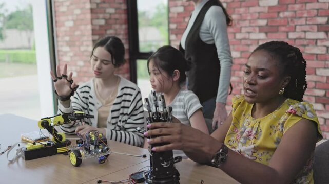 eacher teaches students how to build and design robots in the classroom	