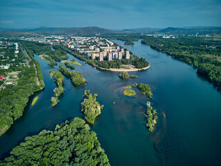 Fototapeta premium Beautiful panoramic aerial drone top-down view to the confluence of the rivers Irtysh and Ulba in UST-KAMENOGORSK (Oskemen), QAZAQSTAN