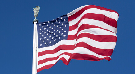 Obraz premium Flag American waving bright sky. American patriotic liberty banner flag. USA democracy freedom symbol flag. American independence culture flag.