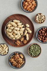 Walnuts, cashews, almonds, hazelnuts, peanuts, pistachios and pumpkin seeds in plates