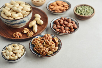 Walnuts, cashews, almonds, hazelnuts, peanuts, pistachios and pumpkin seeds in plates