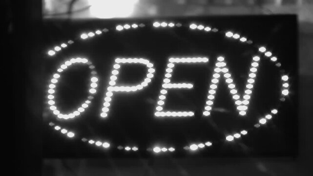 Open sign with flashing LED lights. Shop advertising. Toronto, Canada. Black & white. HD video. 